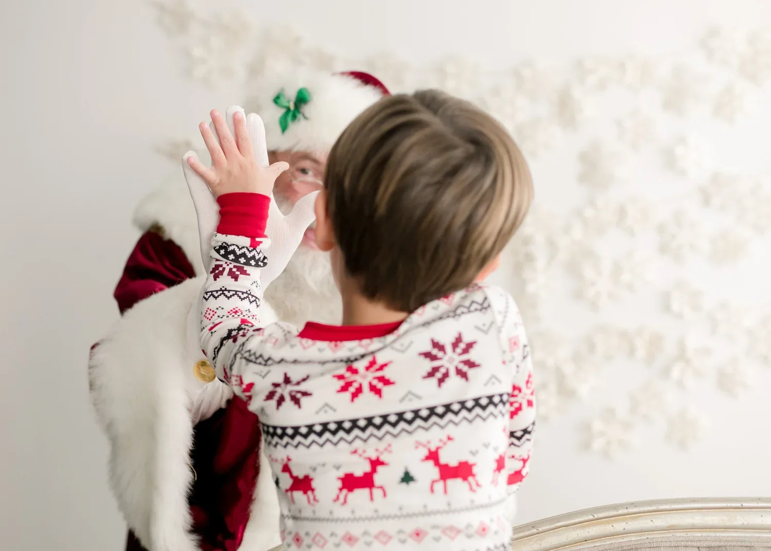 Child giving Santa a high five during the Lynchburg Santa Experience