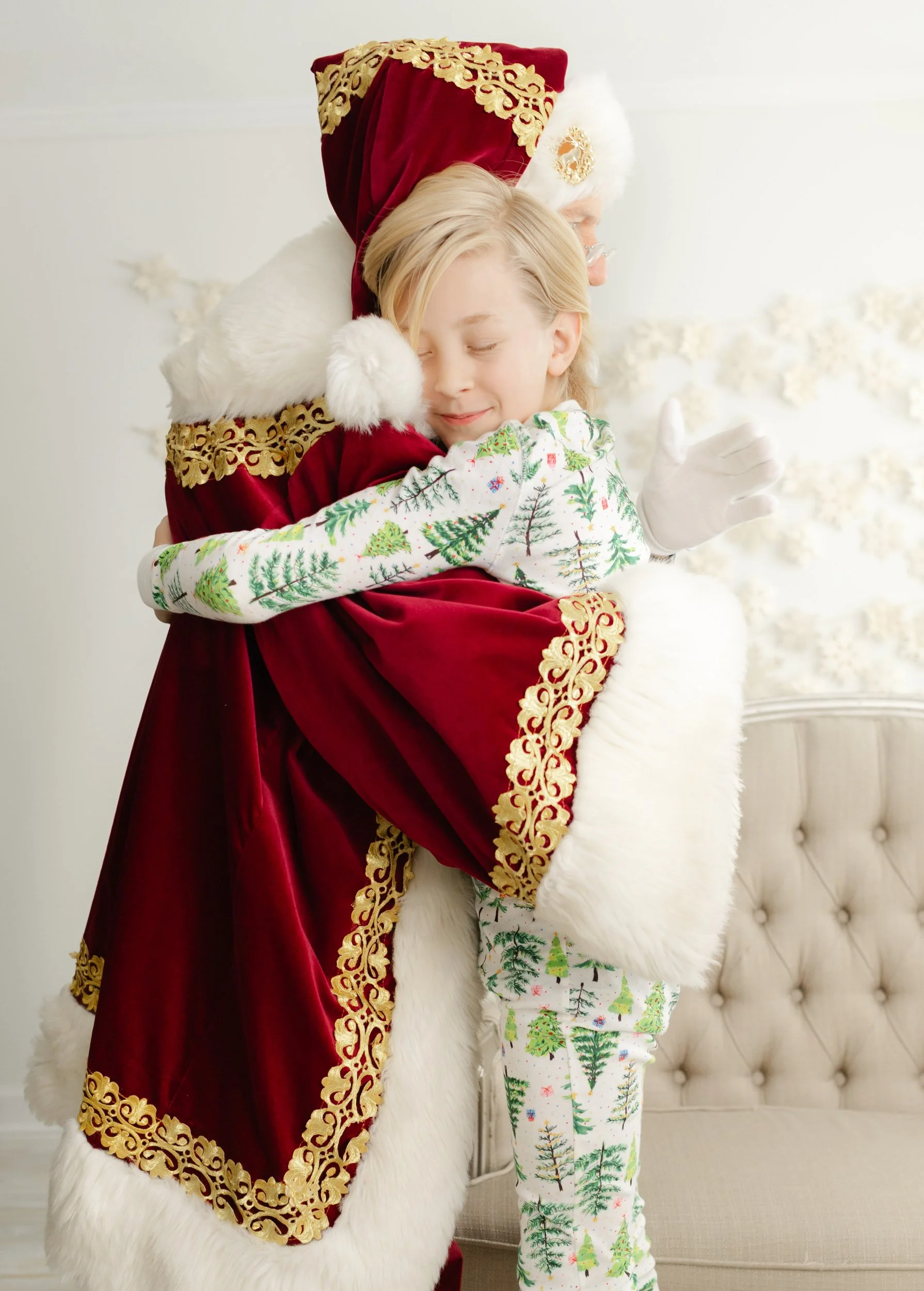 Child hugging Santa during a quiet, personalized Christmas studio experience