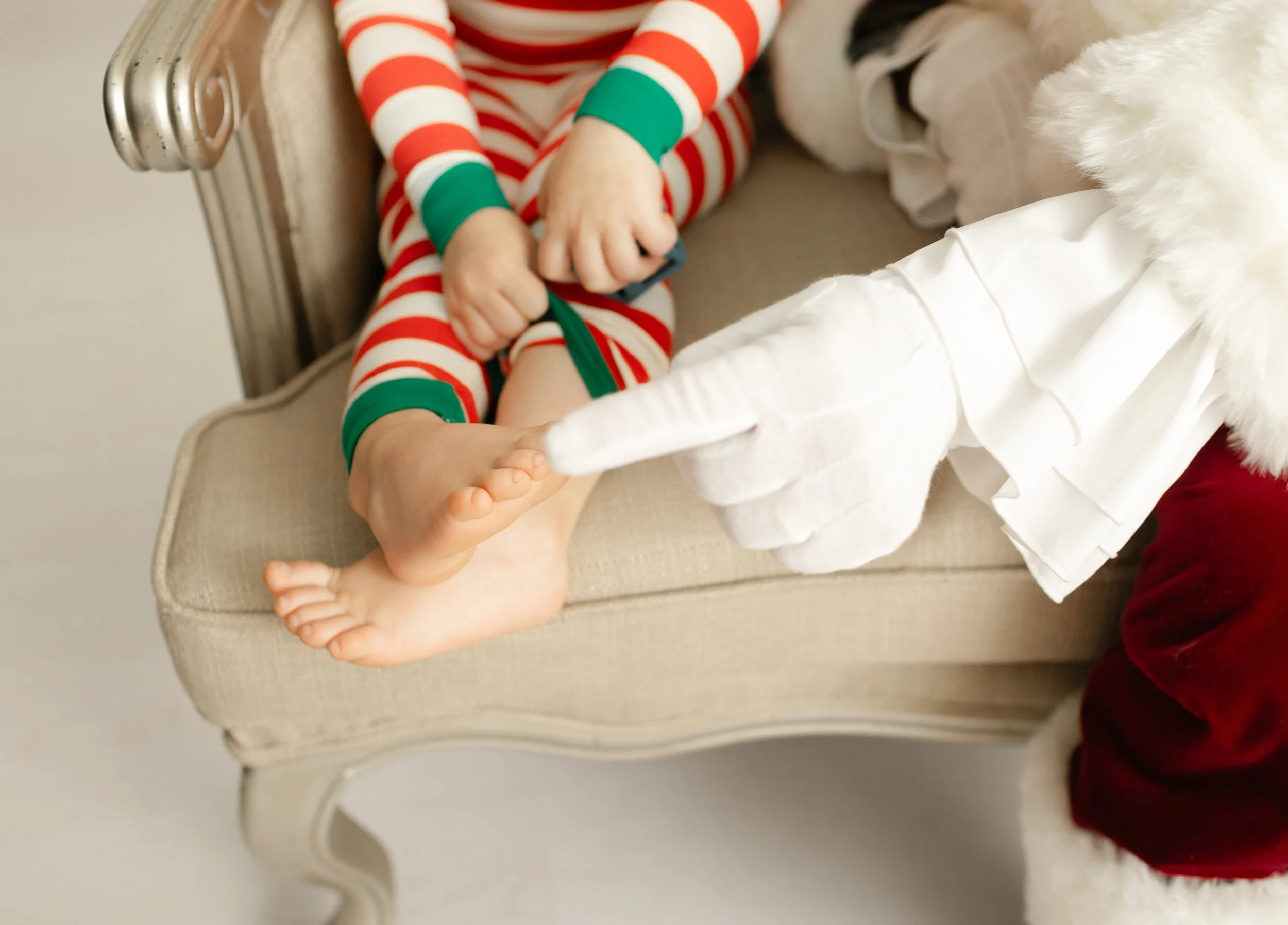 Santa playfully pointing to a child’s toes during a relaxed, child-led visit