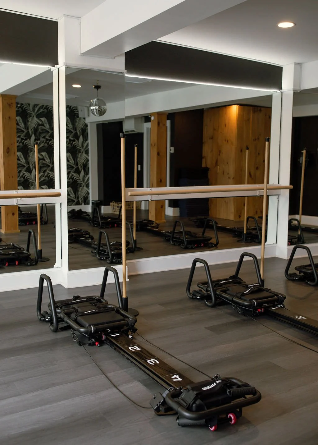 Lava Fitness studio with reformer Pilates machines and wall mirrors.