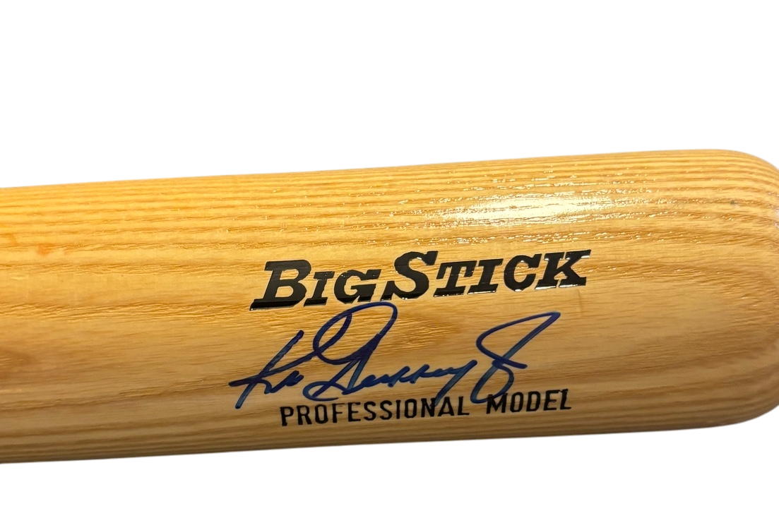 A wooden baseball bat with the words 'Big Stick' and a signature in blue ink, labeled as a professional model.