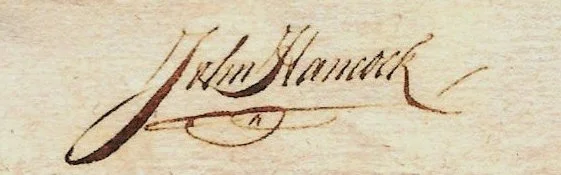 Close-up of an old handwritten signature reading 'J. Hanock' on aged paper.