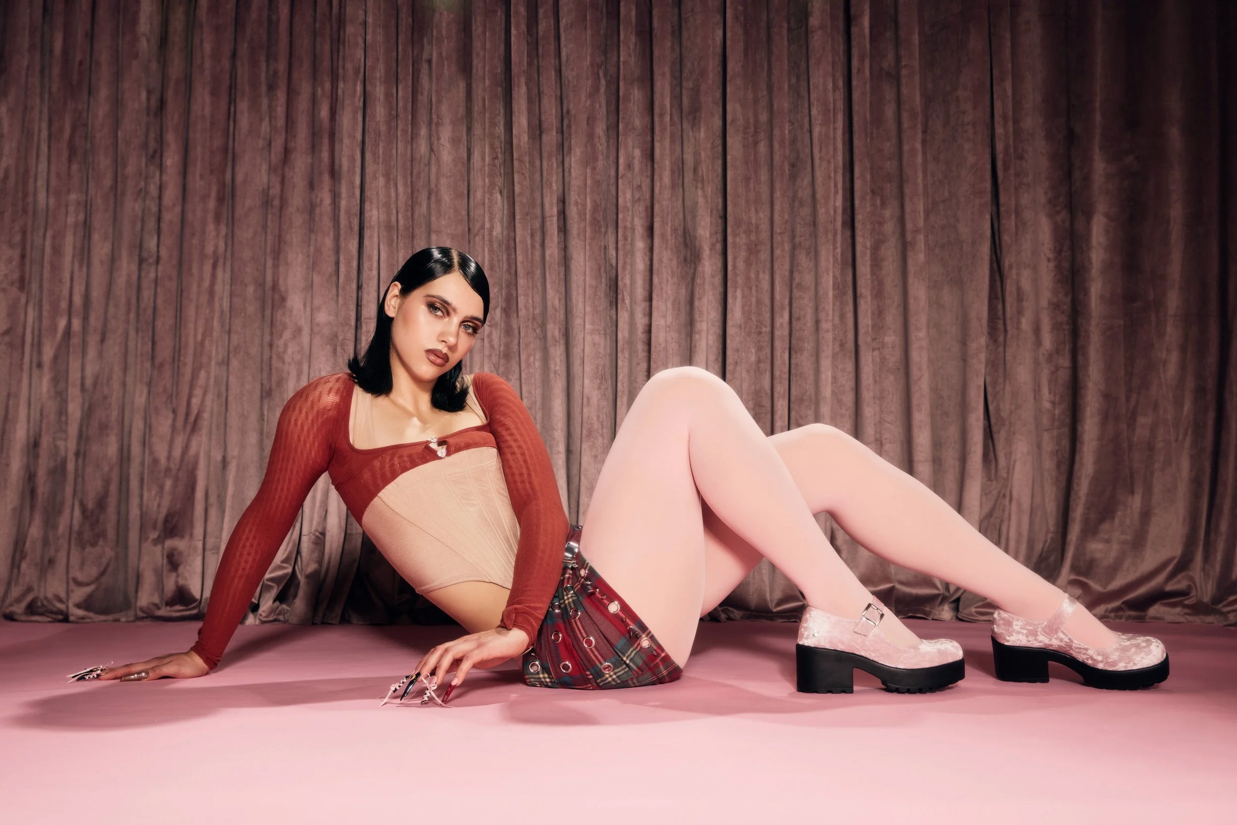 Editorial-style campaign imagery for Playboy x KOI pairing soft pink tones, velvet textures and playful styling with statement platform footwear to build a theatrical, fashion-led product world.