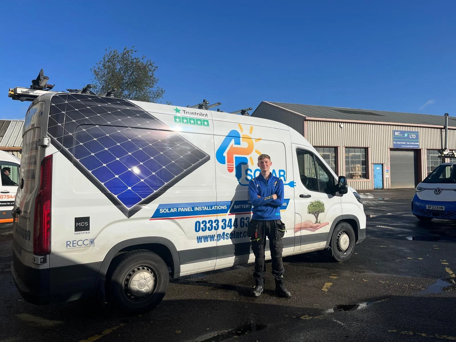 Commercial solar consultant standing beside a P4 Solar installation vehicle during a home solar site assessment.
