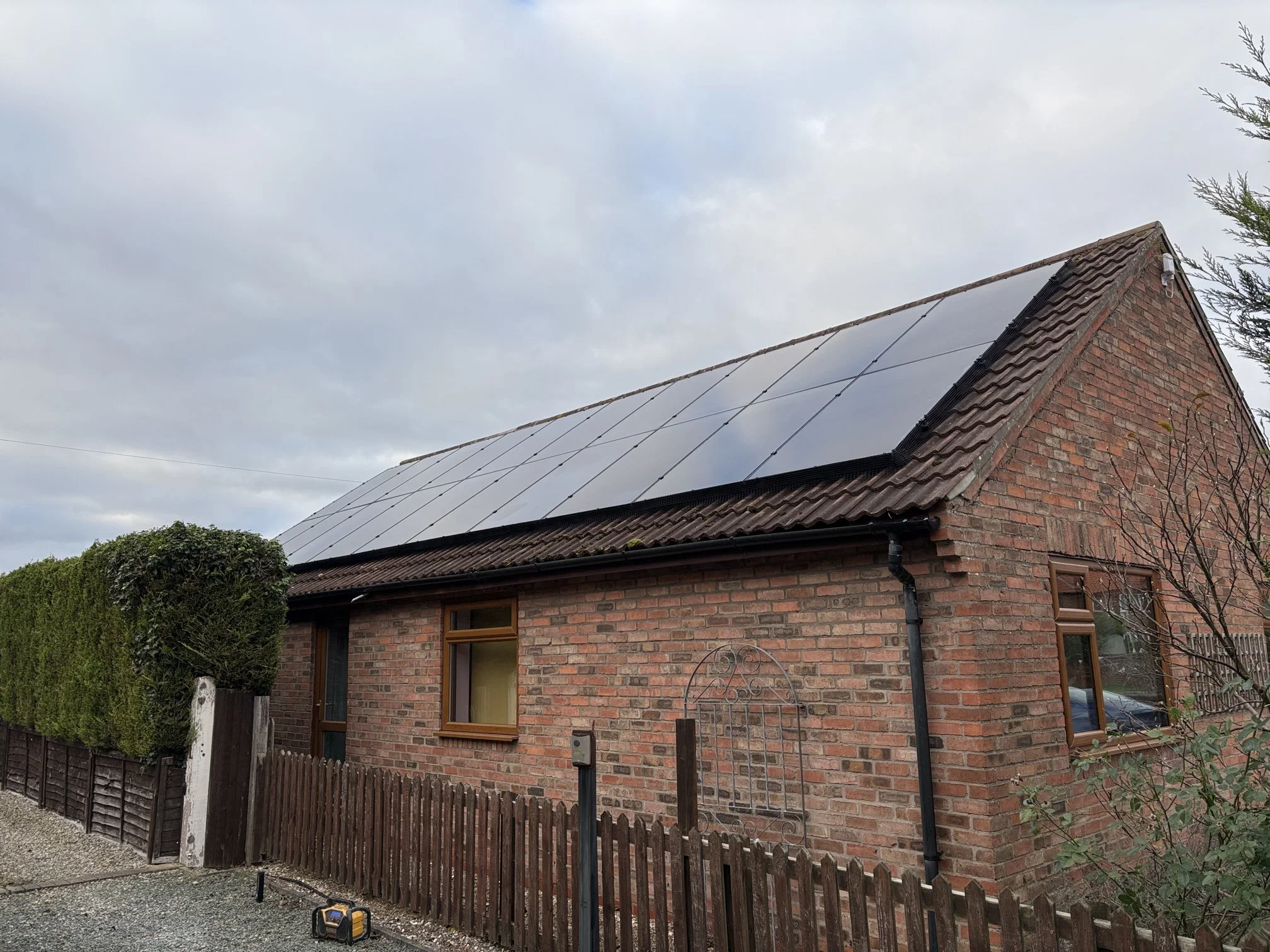 Red brick cottage with in-roof solar panel installation