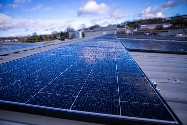 Commercial solar panel installation on a business premises in Manchester helping reduce daytime electricity costs and improve energy efficiency