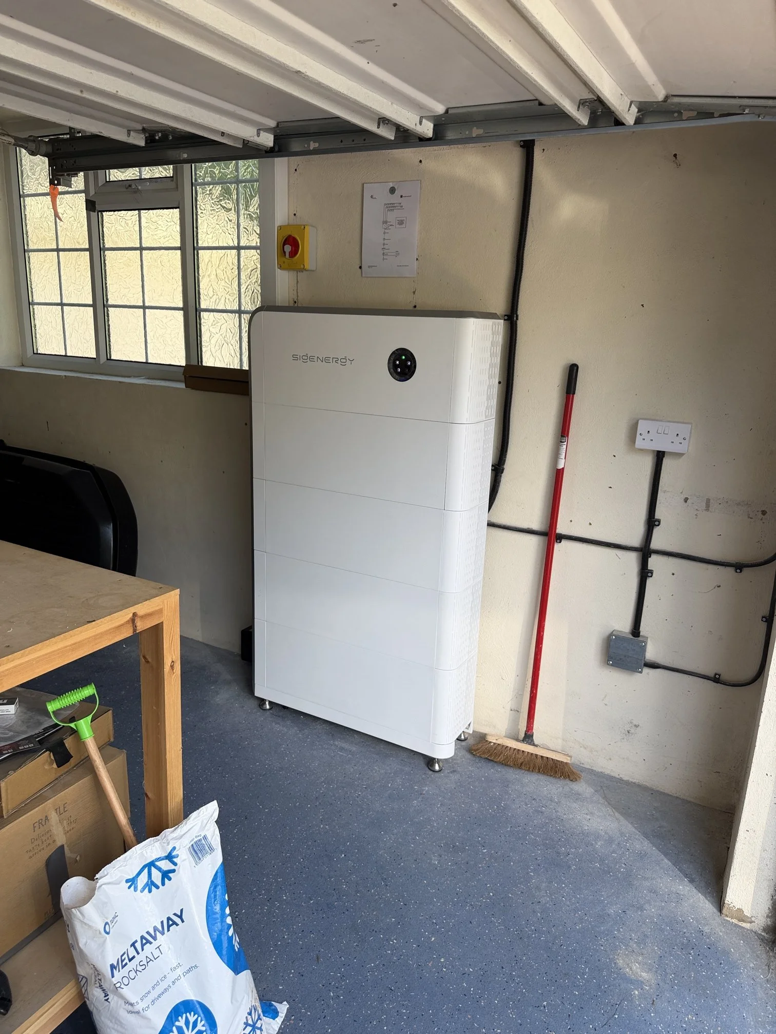 Solar battery storage unit installed in a garage, part of a Bradford solar installation