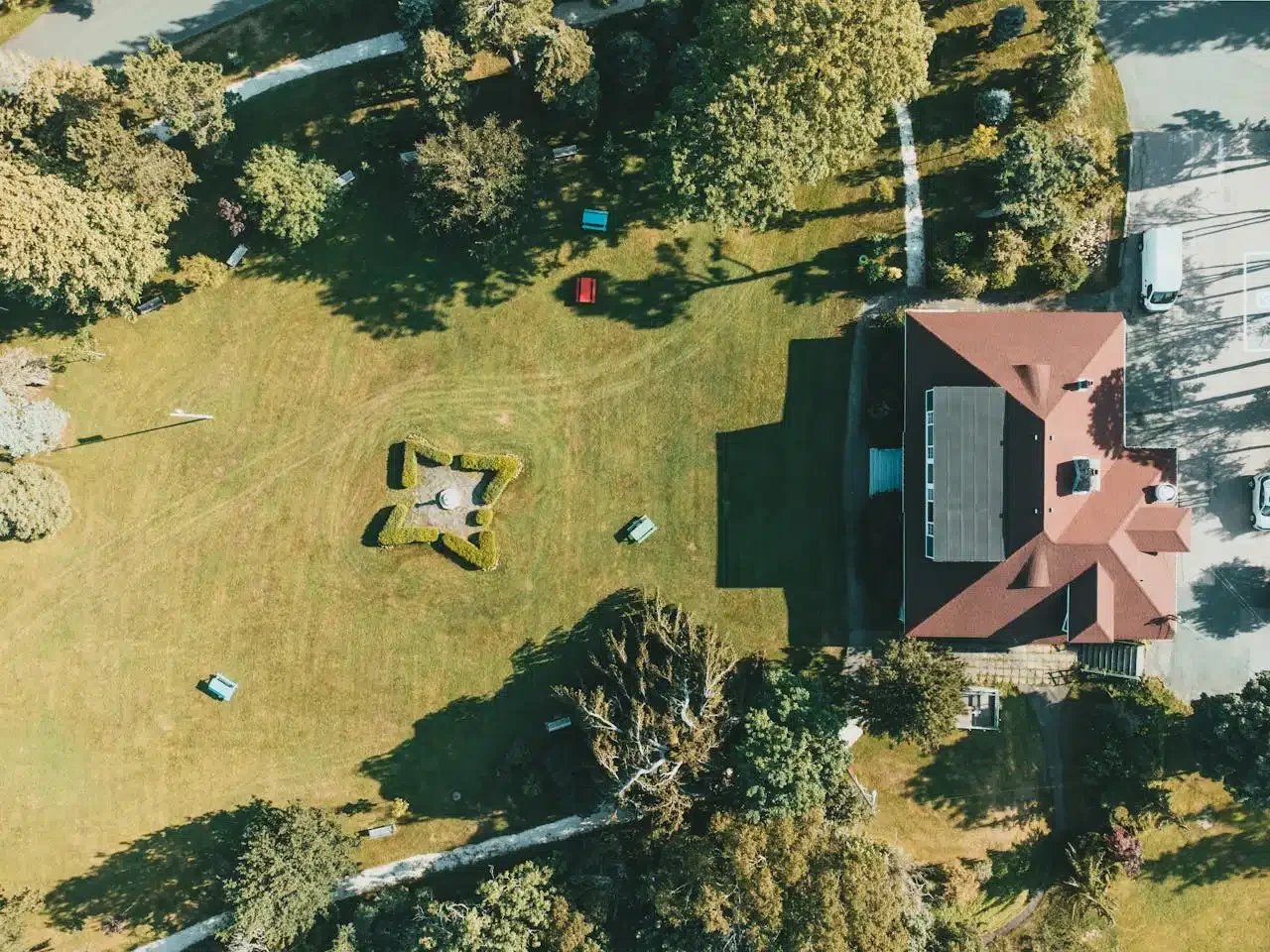 Aerial view of a residential property with rooftop solar panels generating renewable energy.
