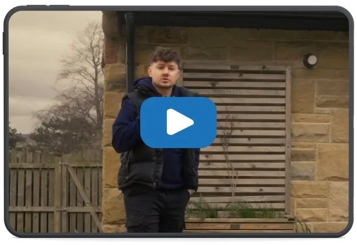 Thumbnail for Myth Buster video explaining whether solar panels are expensive, showing a homeowner outside a house with rooftop solar panels.