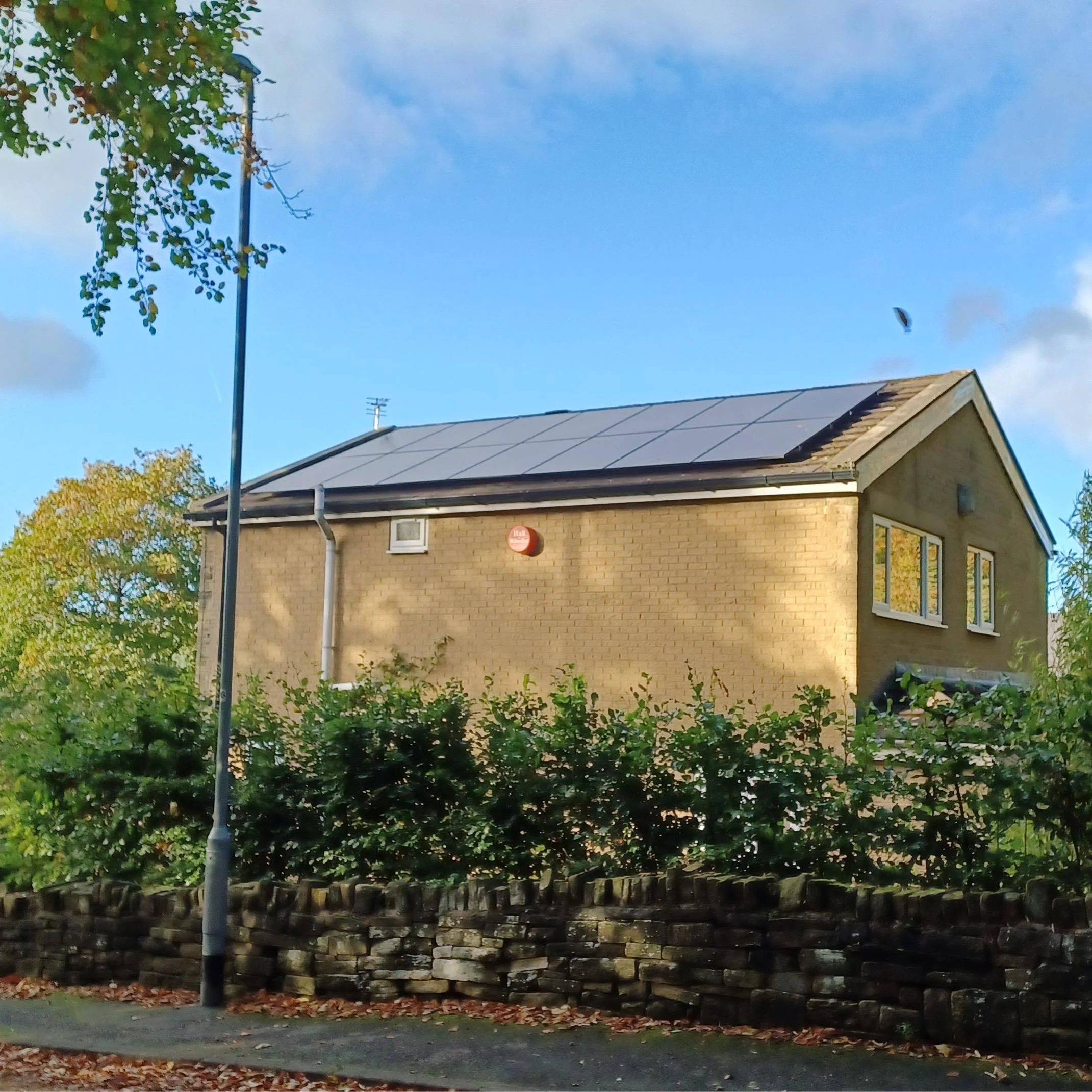 Rendered detached house with solar panels installed on the roof, Keighley and Bingley area
