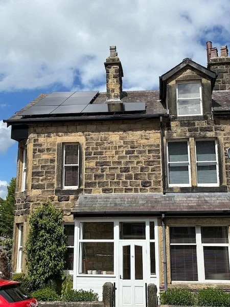 Large stone-built detached house with solar panels on the roof, Ilkley