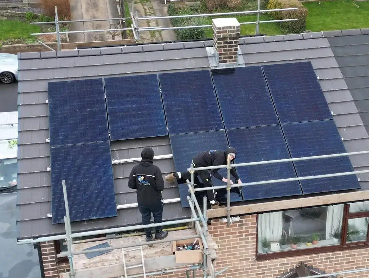 Solar panel installation taking place on a residential roof, demonstrating a typical domestic solar project.  Or: