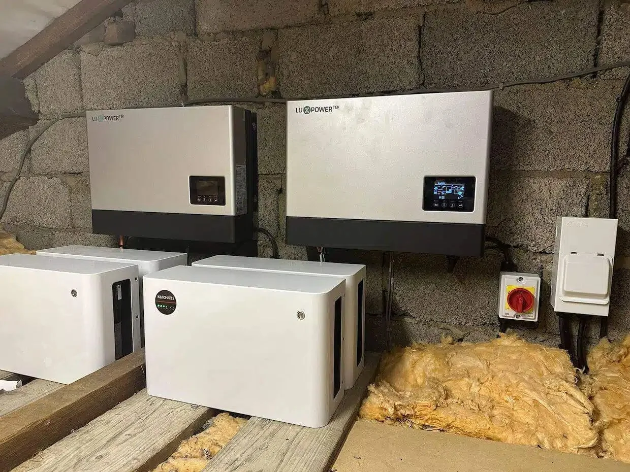 Battery storage and inverter system installed in a utility space, featuring Lux Power hybrid inverters and battery units designed to store solar energy and improve home energy efficiency.