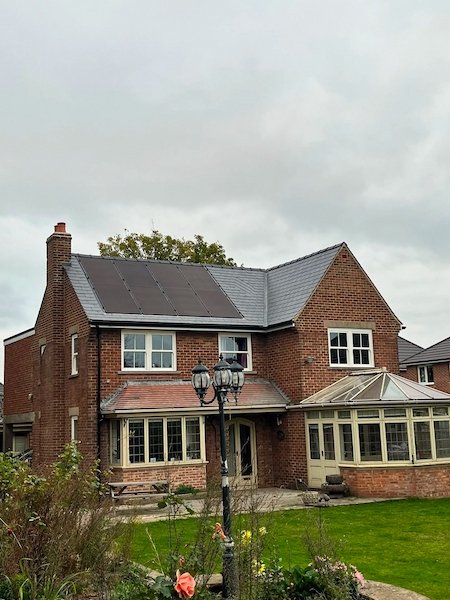 Red-brick detached house with solar panels installed on the roof, Harrogate