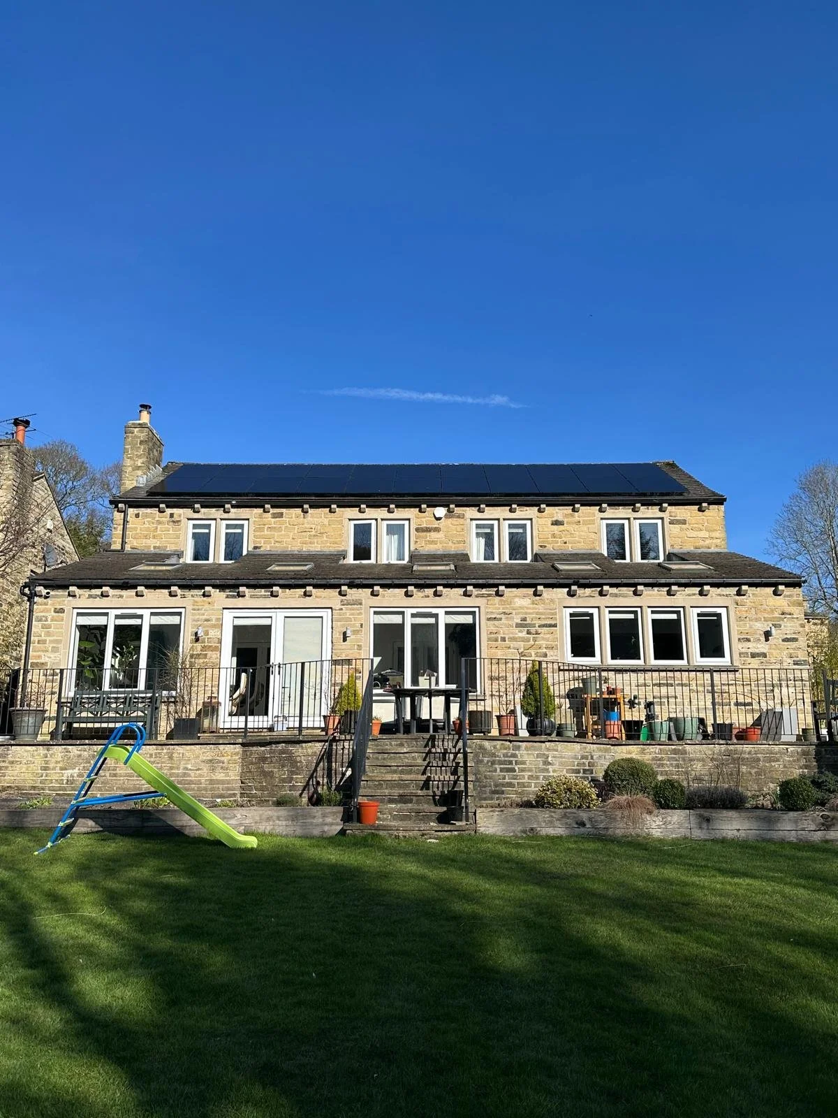 Large residential property with rooftop solar panels installed to improve energy efficiency and lower running costs.