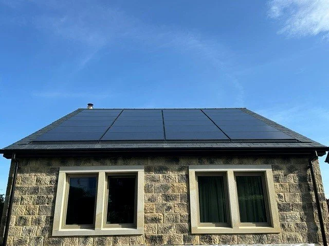 Residential property with roof-mounted solar panels installed to improve energy efficiency and lower energy bills.