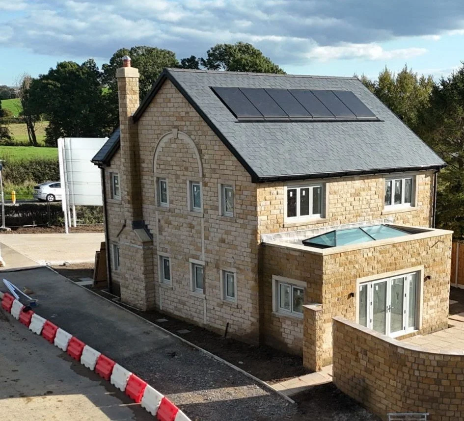 New build residential home with rooftop solar panels installed as part of a small housing development.