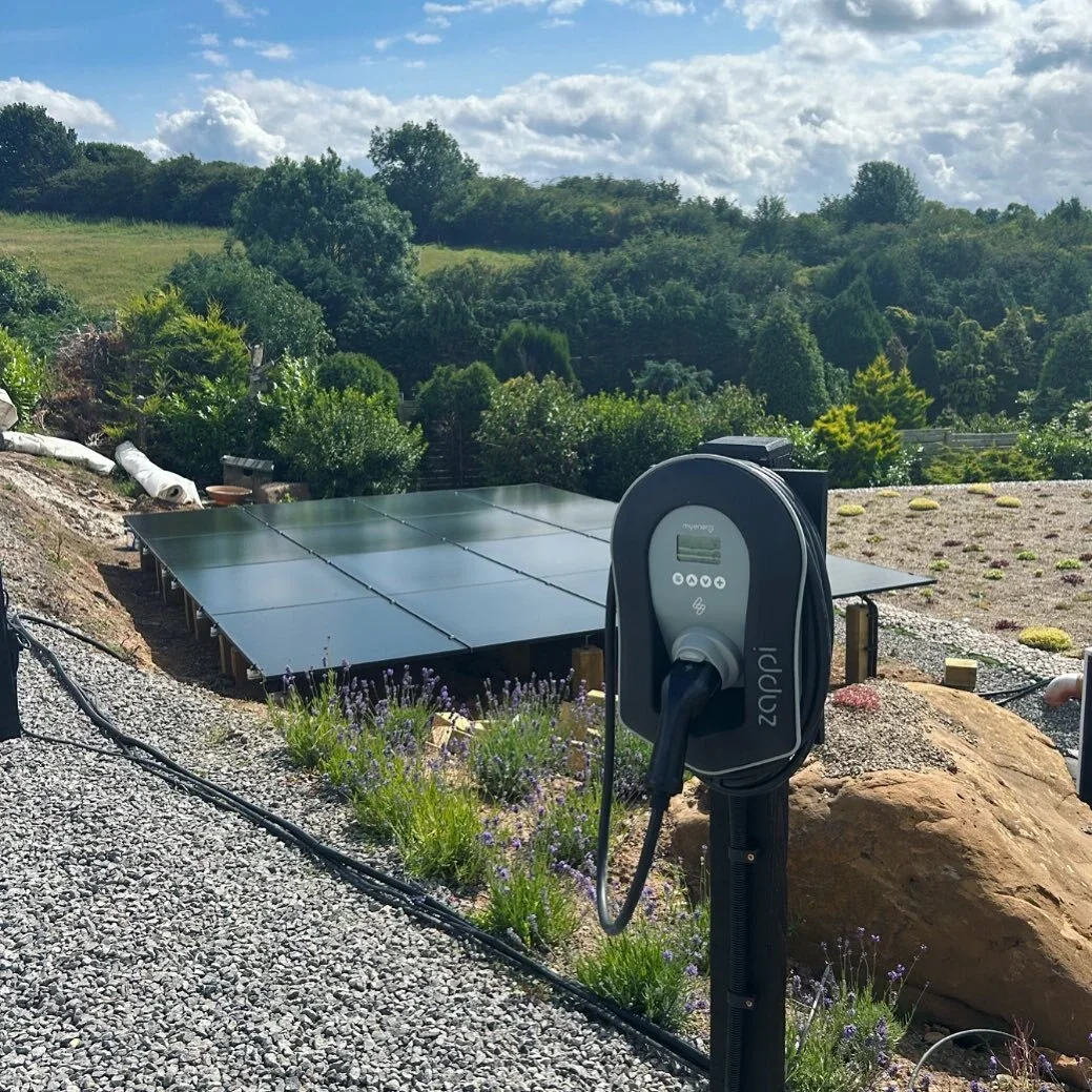 Ground-mounted solar panels with EV charger at rural UK property