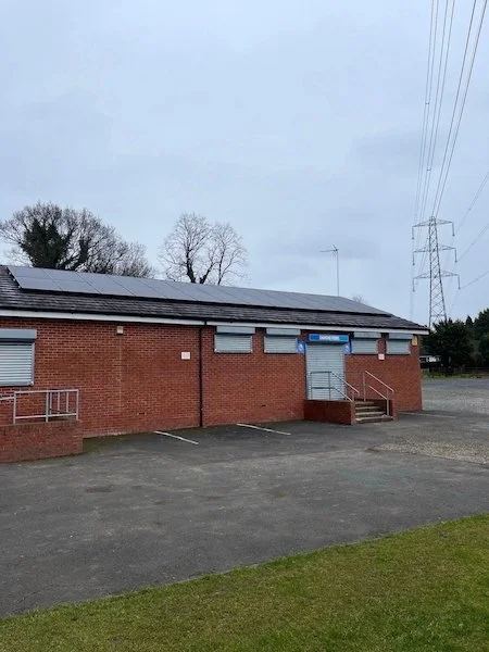 Solar panels installed on the roof of AFC Monton sports club, community solar installation, Manchester