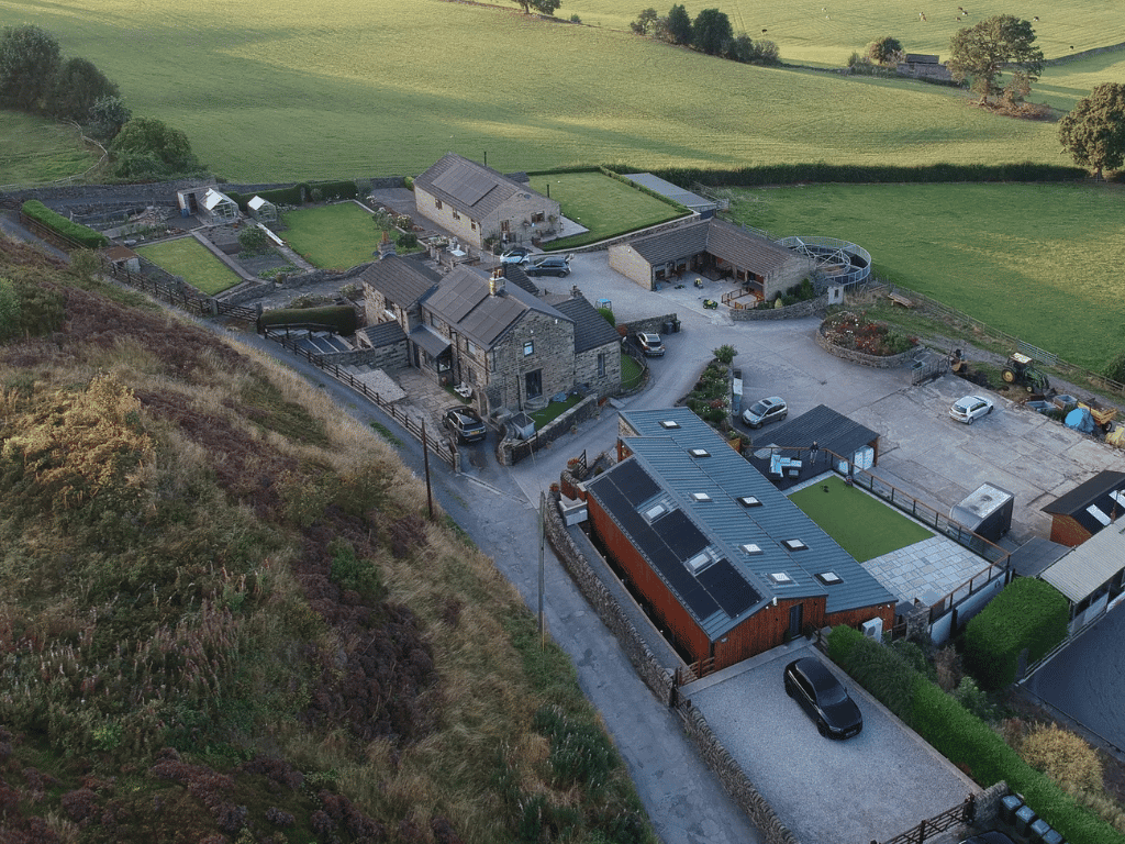 Aerial view of farm with solar panel installations on multiple buildings