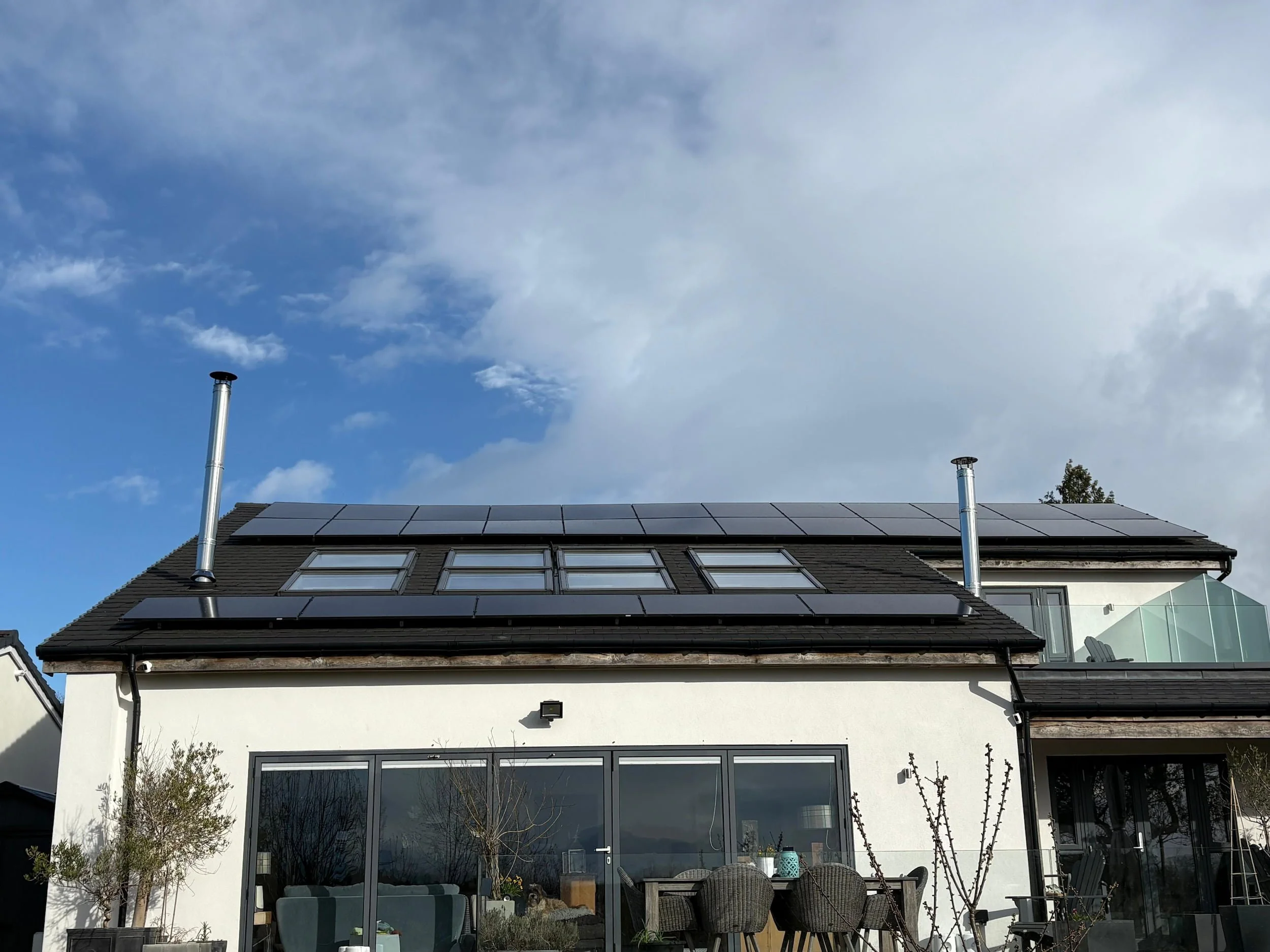 Modern residential property with roof-mounted solar panels generating clean renewable energy and reducing electricity costs.