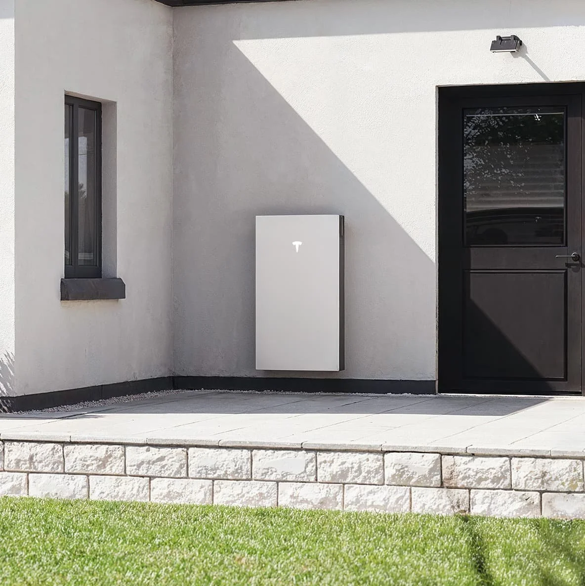 Residential solar battery storage system installed beside a modern home for efficient renewable energy storage.