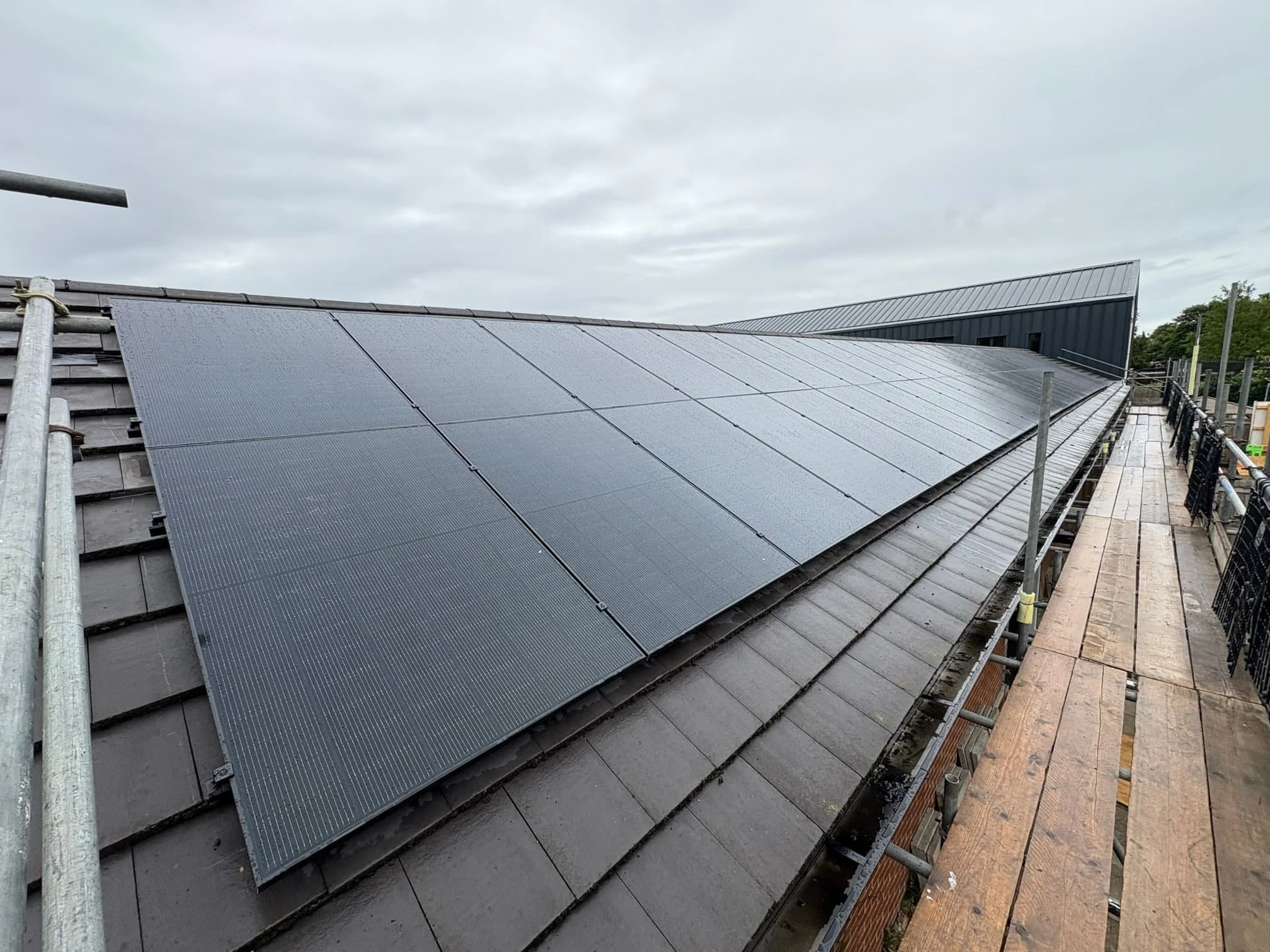 Solar panel installation on a school building roof, helping educational facilities reduce energy costs, lower carbon emissions and generate renewable electricity.