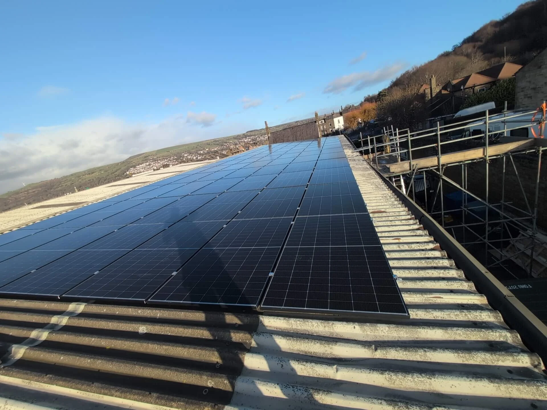 Large commercial rooftop solar panel installation helping reduce business energy costs