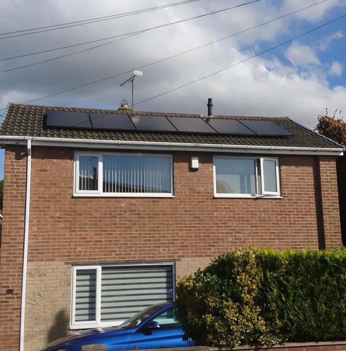 Aerial view along a row of solar panels installed on a terraced roof, Doncaster