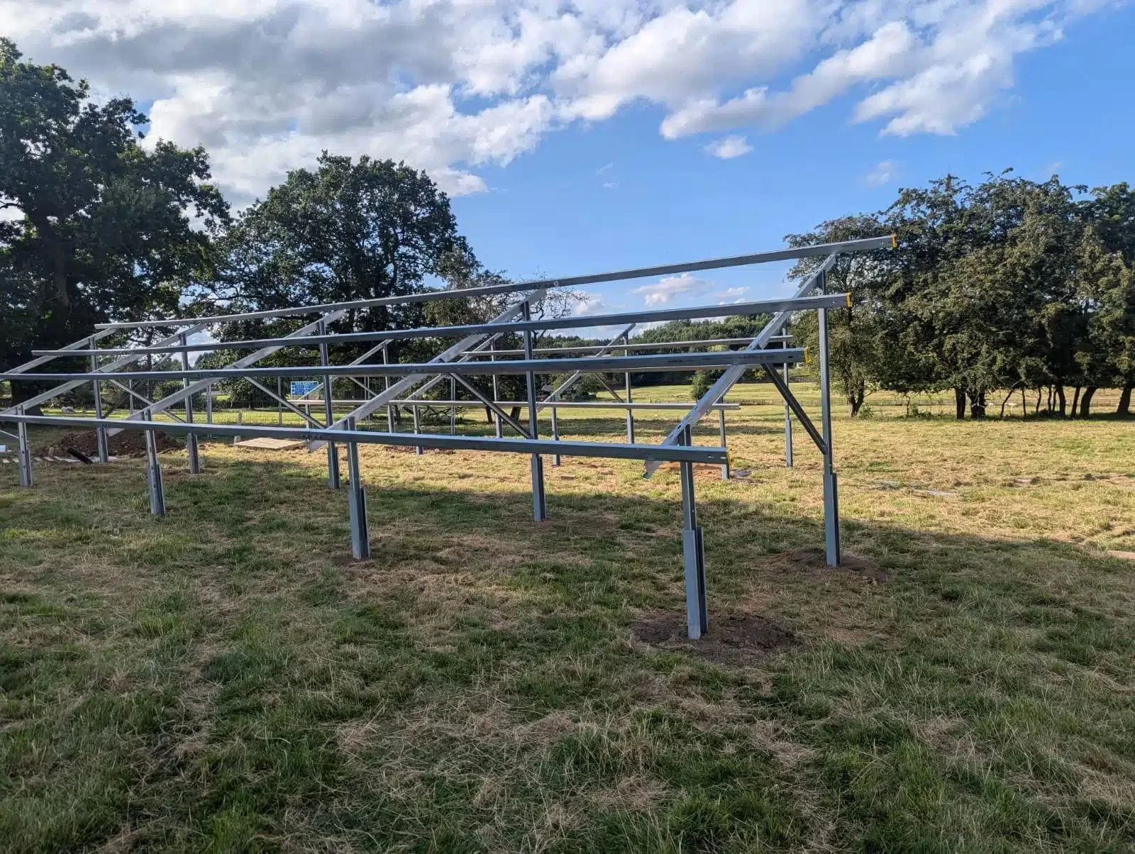 Ground-mounted solar panel framework under construction at a rural property in Beckwithshaw, prepared for the installation of a large solar energy system.