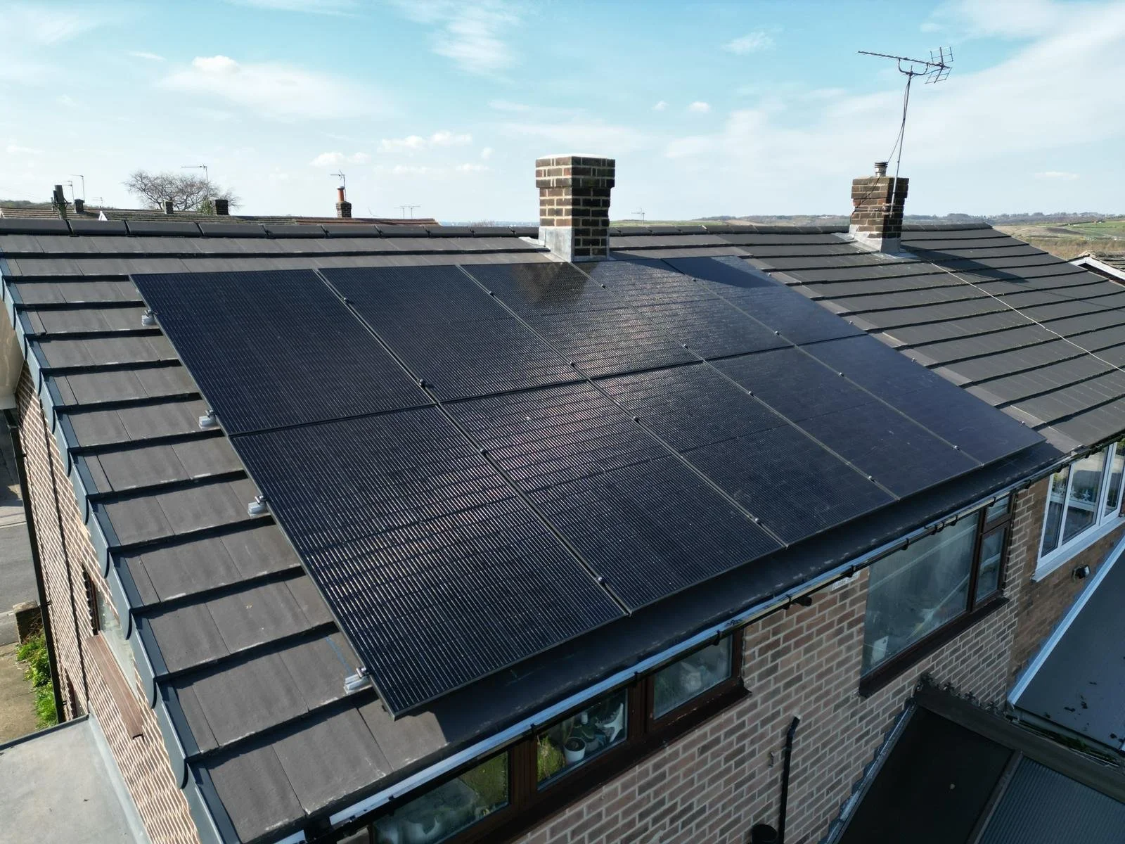 Solar panels installed across a roof with two chimneys, Castleford