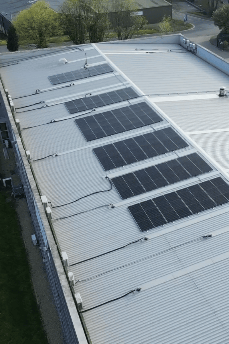 Flat roof commercial solar panel system generating renewable electricity