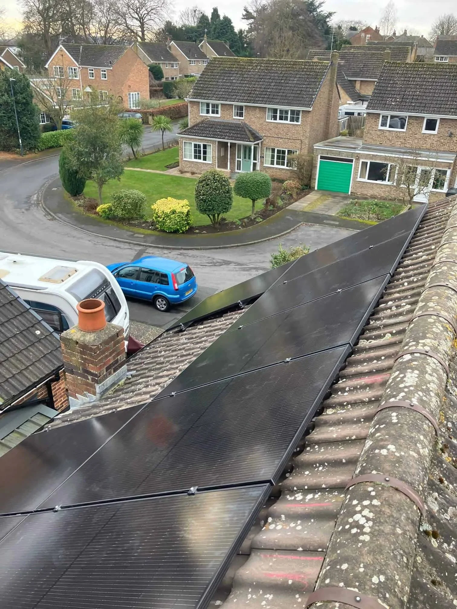 Close-up of black rooftop solar panels installed on a tiled residential roof, maximising available roof space to generate clean, renewable energy and reduce household electricity costs.