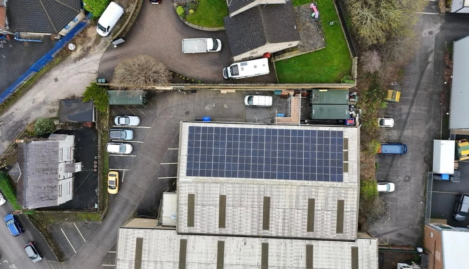 Aerial view of residential property with rooftop solar panels