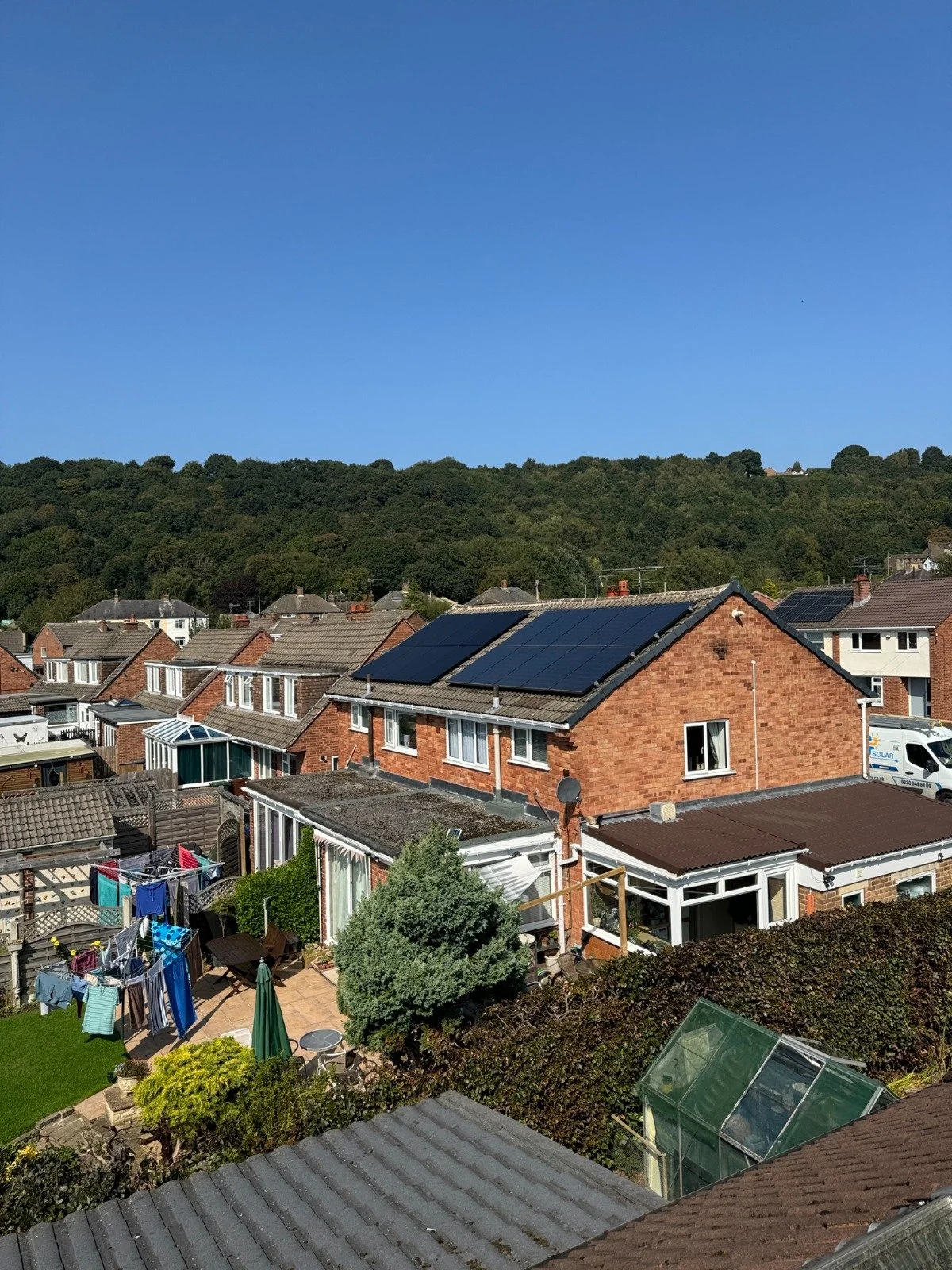 Residential properties with rooftop solar panels installed to generate renewable energy and reduce household electricity costs.