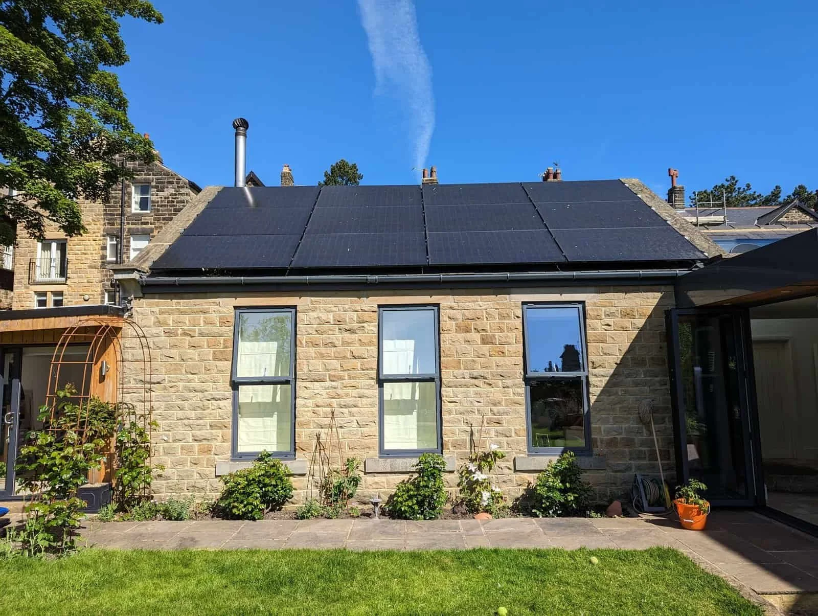 Residential solar panel installation on stone house roof in the UK