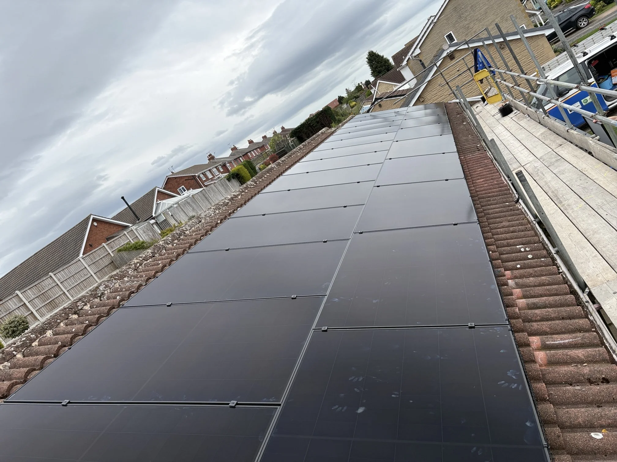 Roof-mounted solar panels installed on a residential property, generating renewable energy and reducing household electricity costs.