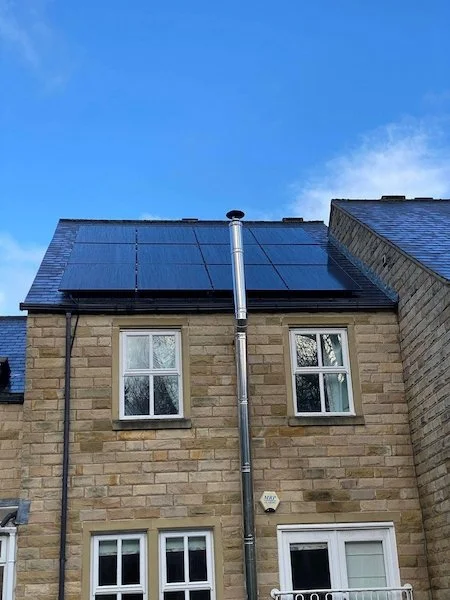 Stone terraced house with solar panels installed on the roof, Ilkley and Bradford area