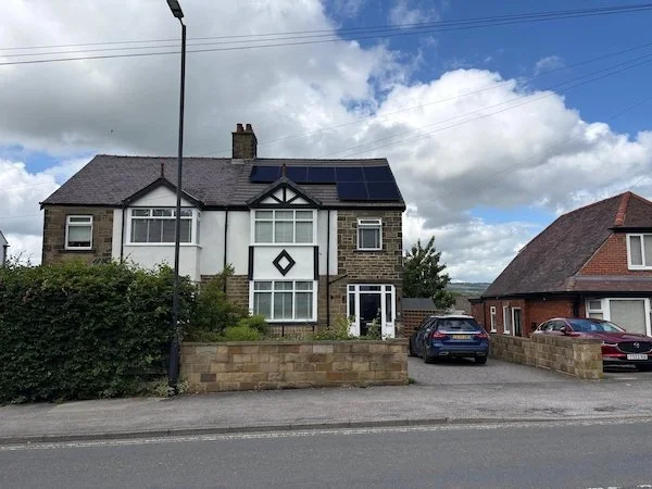 Stone semi-detached house with solar panels installed on the roof, Ilkley