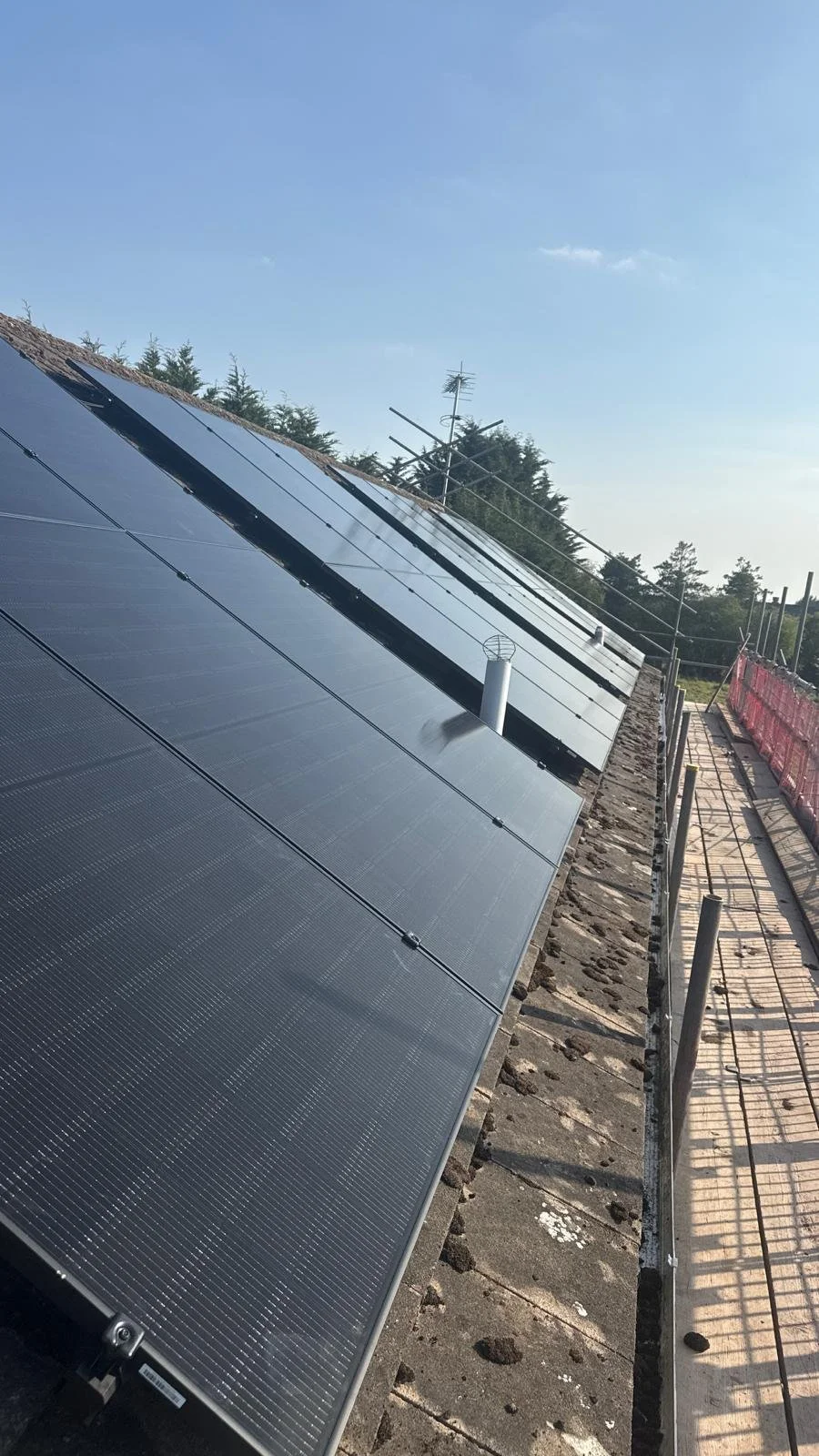 Large-scale rooftop solar installation on a new build construction project.