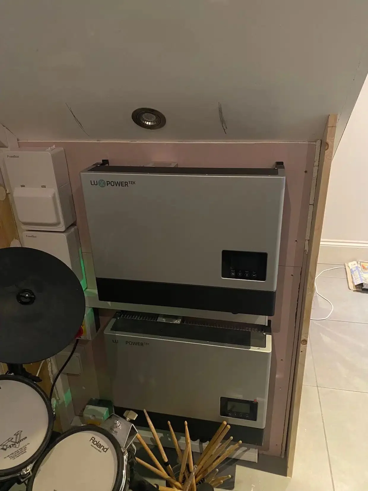 Home battery storage and inverter system installed indoors, featuring two LuPowerTek battery units stacked vertically to provide efficient energy storage, reduced electricity costs, and compatibility with future solar power integration.