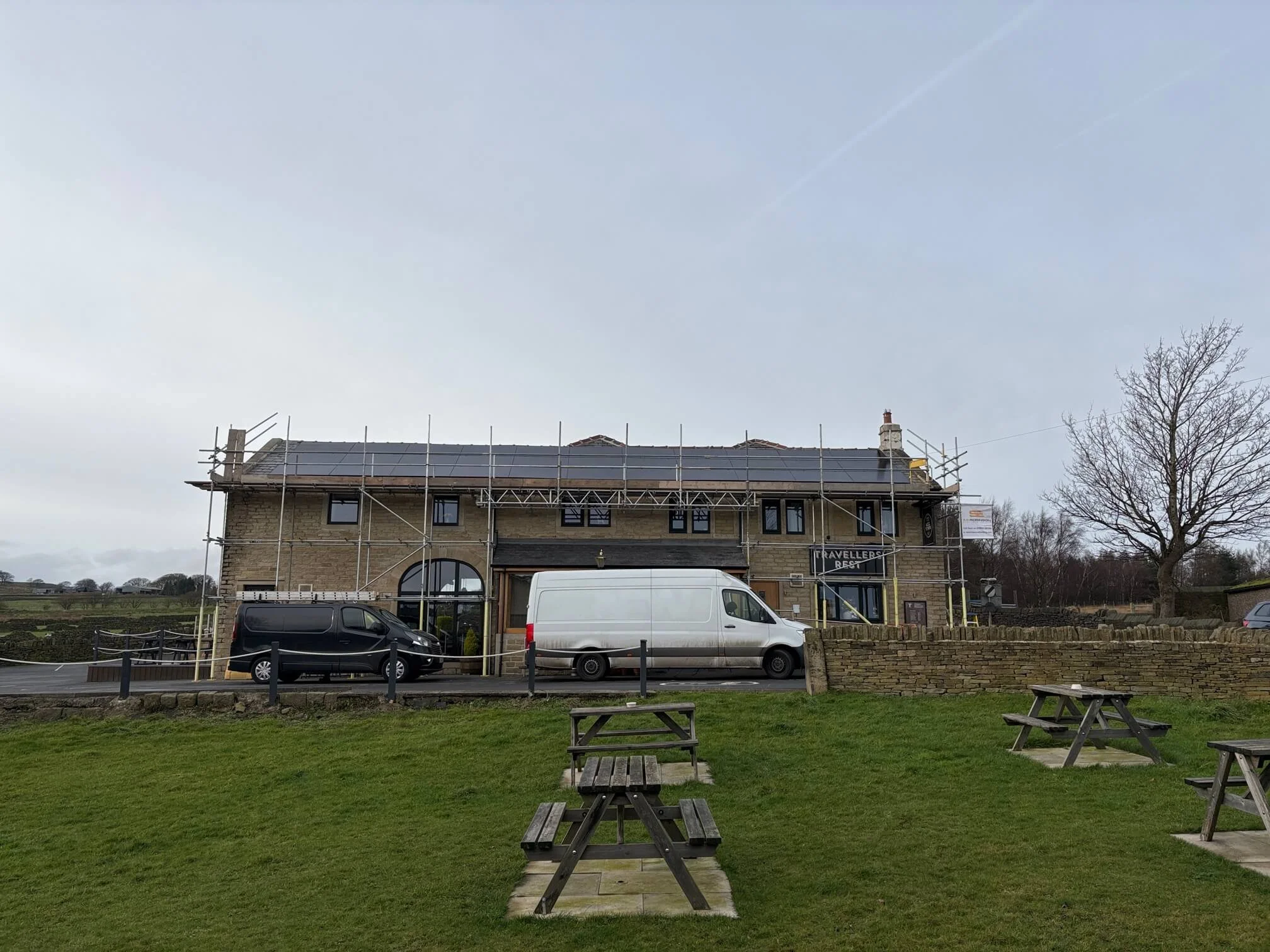 Solar panels and scaffolding on roof of Travellers Rest pub in Meltham