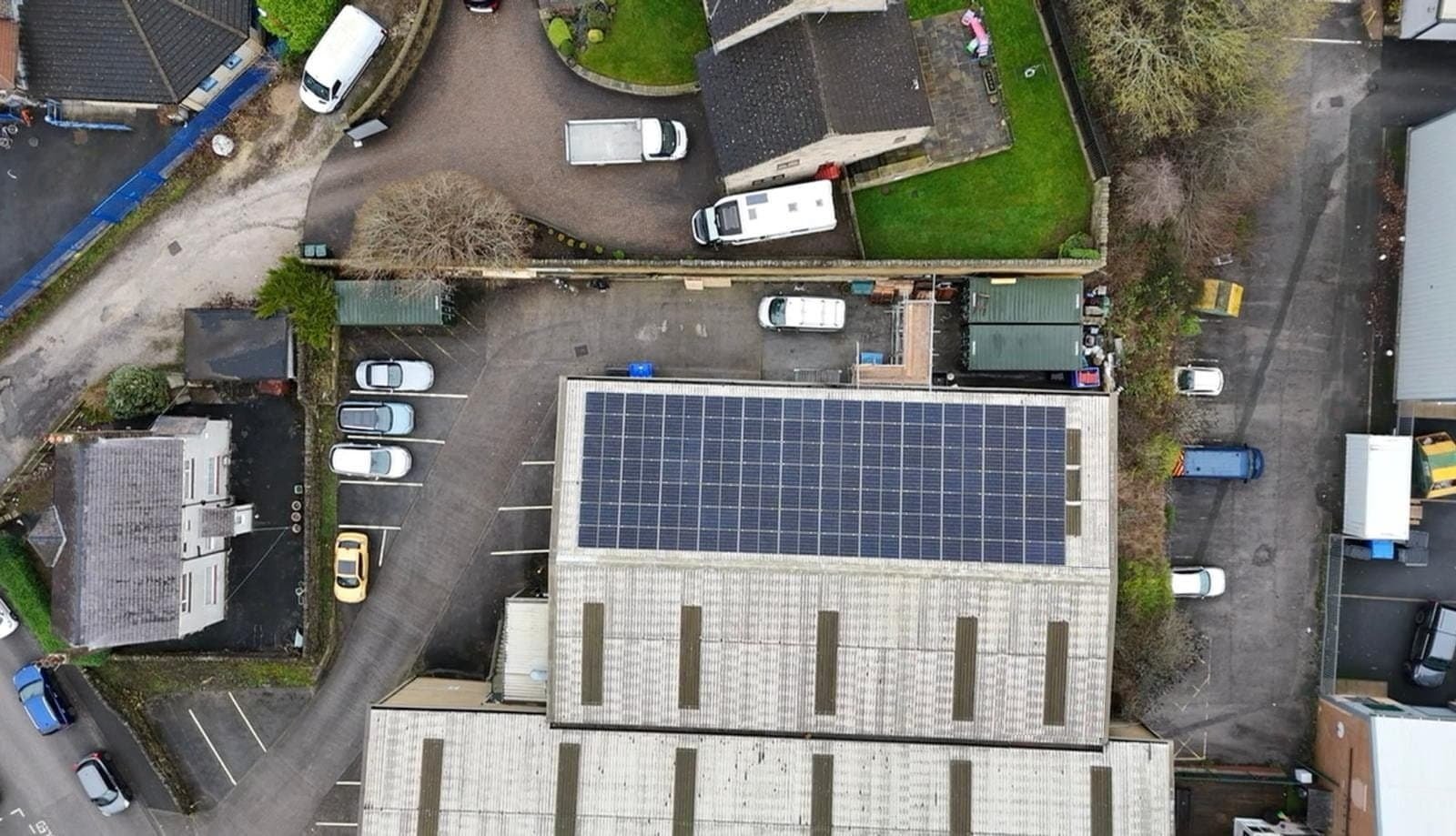 Aerial view of residential property with rooftop solar panels