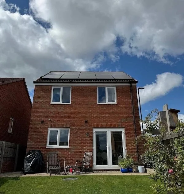 Red-brick detached house with solar panels installed on the roof, Sheffield and Barnsley area