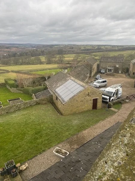 Aerial view of a rural property with solar panels installed on an outbuilding roof, Harrogate area