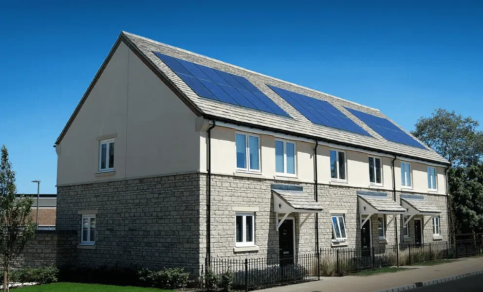New-build residential homes fitted with solar panels as part of a sustainable renewable energy development.