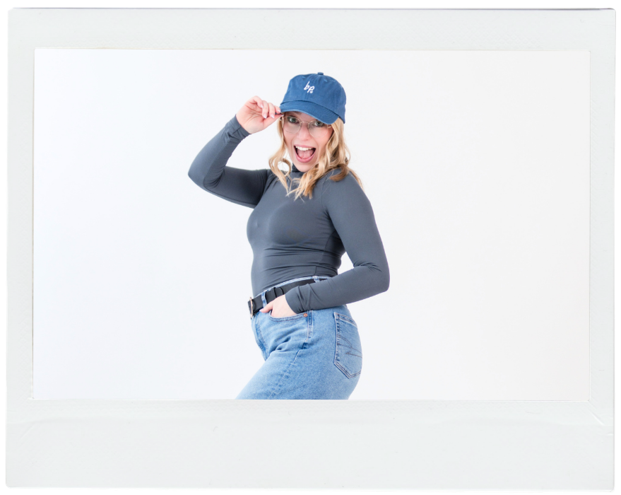woman similing with a blue baseball cap on