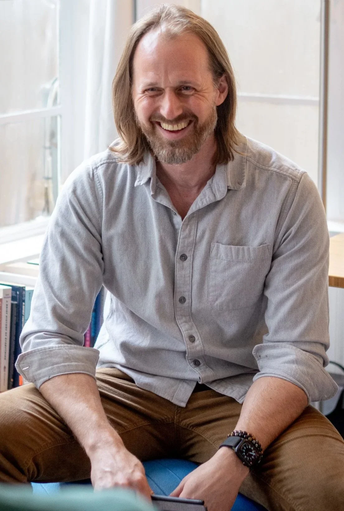 Dan Reed, PhD sitting on ball and laughing.