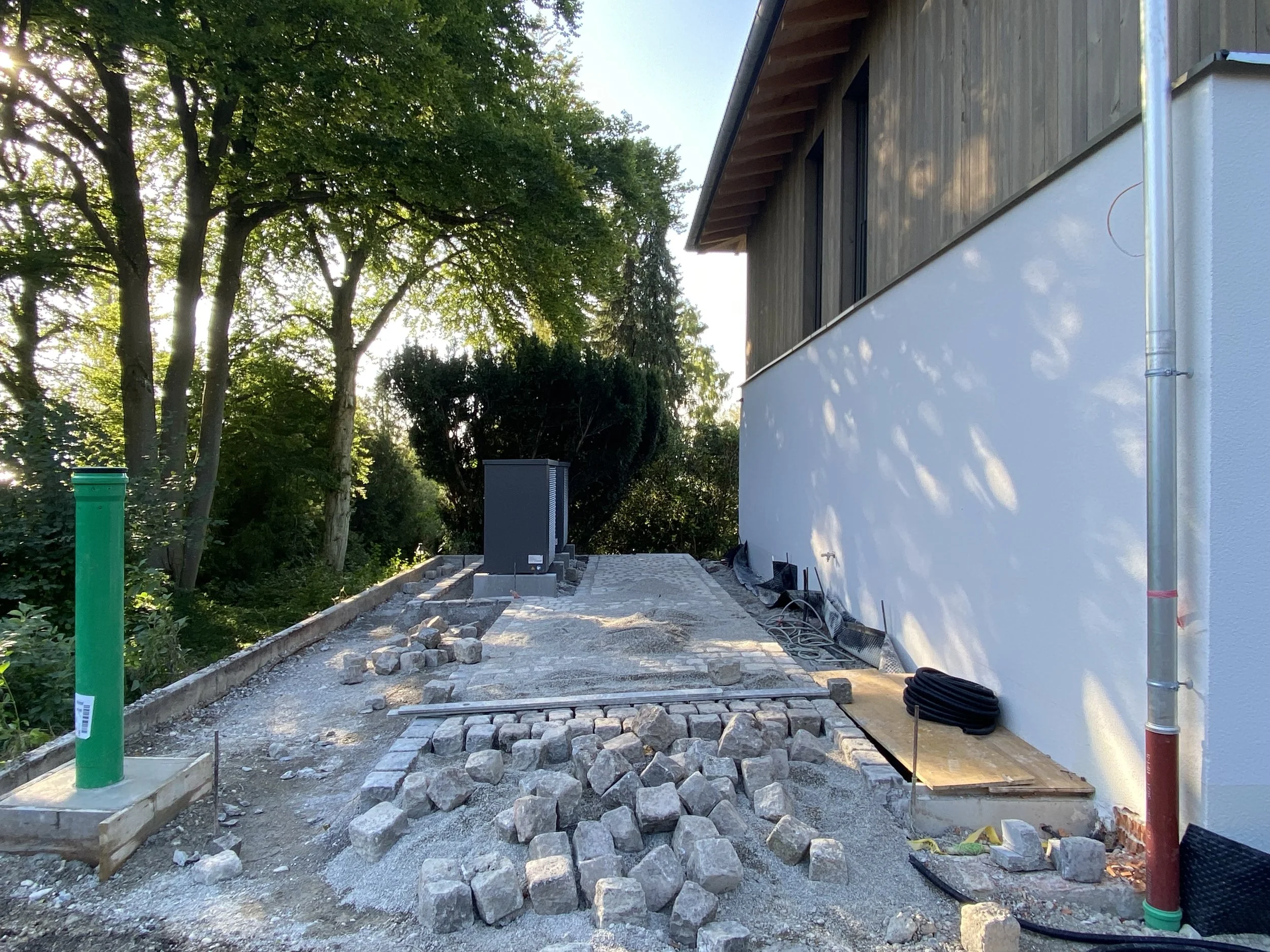 Baumarkt Baumaßnahmen im Außenbereich eines Hauses mit Steinen, Rohren und Bauarbeiten.