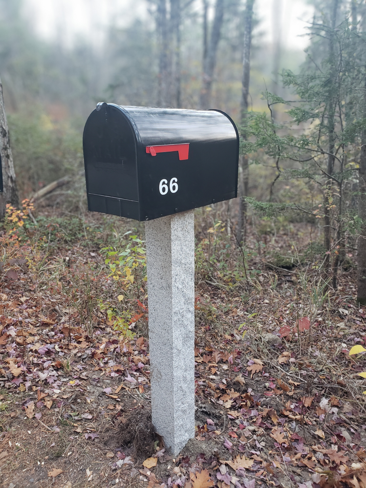 extra large gibraltar mailbox on top of a granite mailbox post